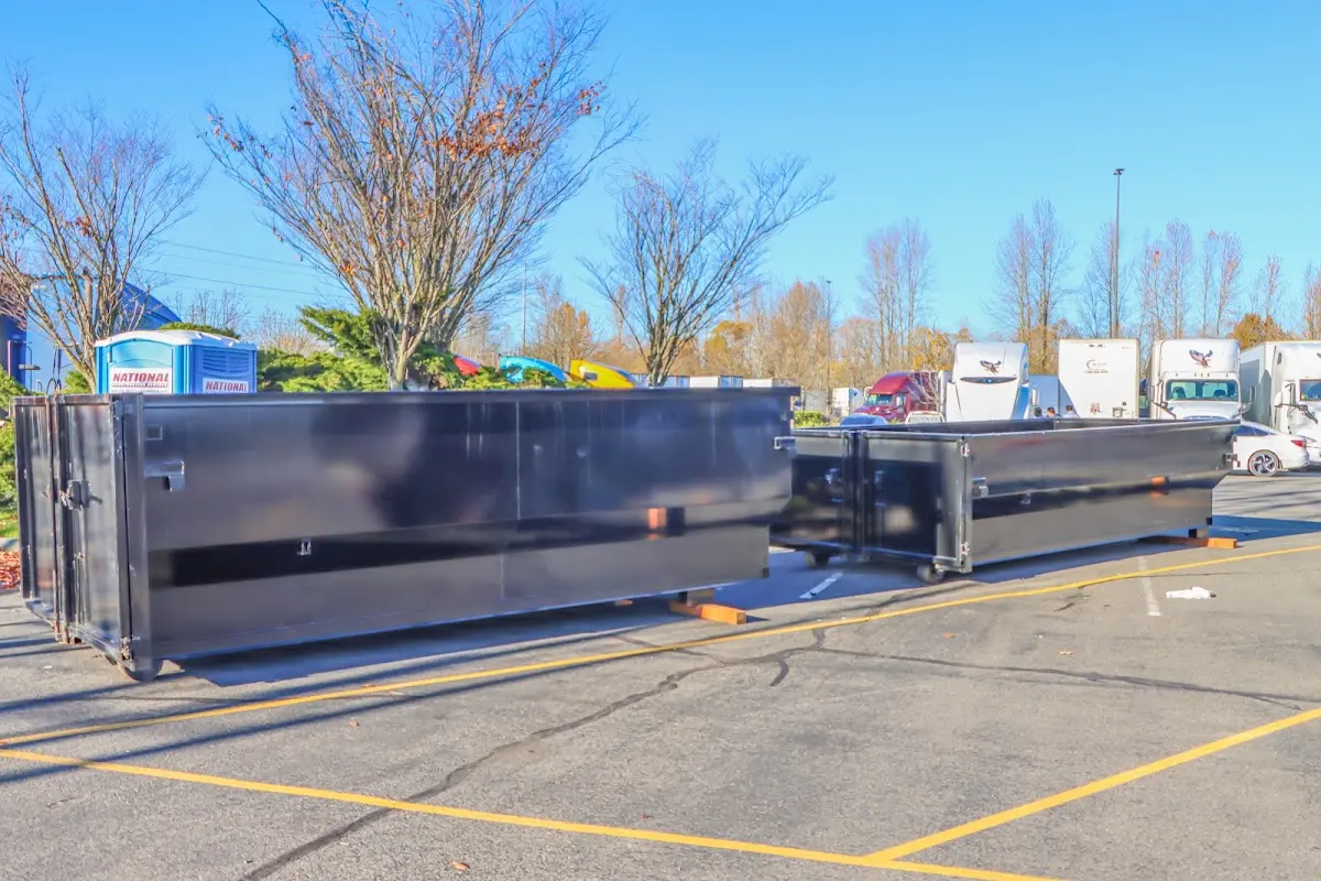 Professional dumpster rental service with roll-off container on residential driveway in Skippack